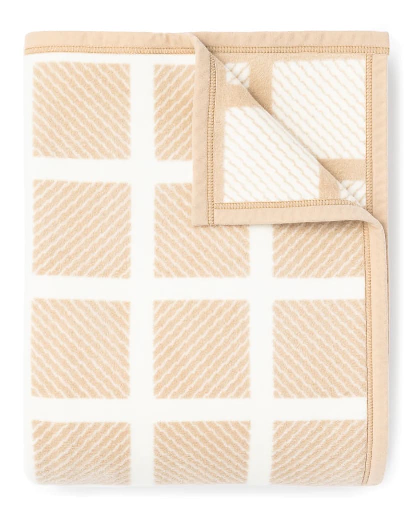 Meticulously crafted to embody comfort and style, The Westerly Co, Commodore blanket is an elegantly woven diamond pattern, artfully intersected by creamy white stripes. It's the perfect addition to any space that appreciates a fusion of time-honored and modern design. It's an instant coastal classic.