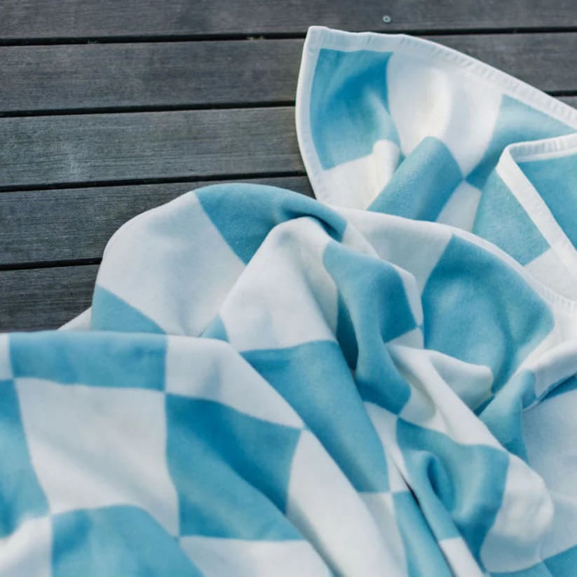 The texture of The Westerly Co Boardwalk blanket is incredibly soft. Whether it's a cold day by the sea or just a way to cozy up inside, this soft and modern blanket in blue and white will envelop you in warmth.