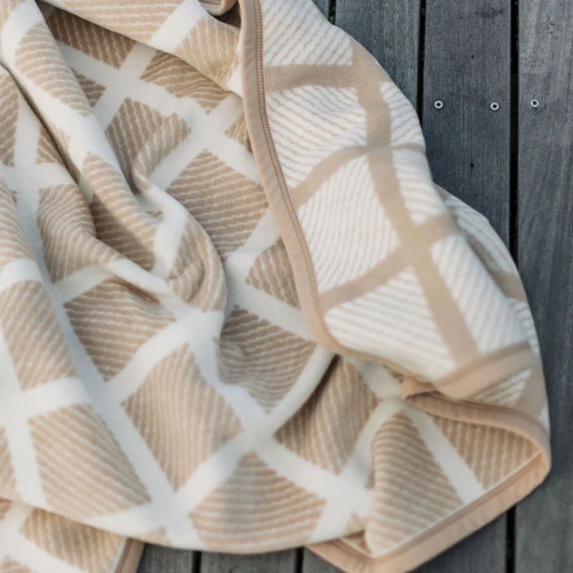 The texture of The Westerly Co Commodore blanket is incredibly soft. Whether it's a cold day by the sea or just a way to cozy up inside, this soft and modern blanket in sand and white will envelop you in warmth.